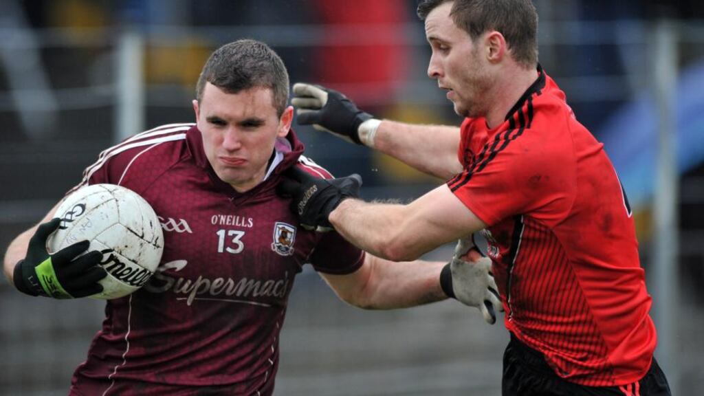 Galway’s Michael Martin holds off Down’s Owen Costello in Tuam. Photograph: Ray Ryan