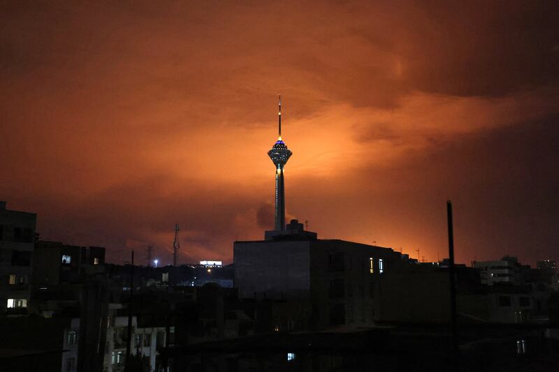 Milad Tower, the tallest tower in Iran at 435m, is backlit following air strikes on Tehran on Saturday night. Photograph: Atta Kenare/AFP via Getty