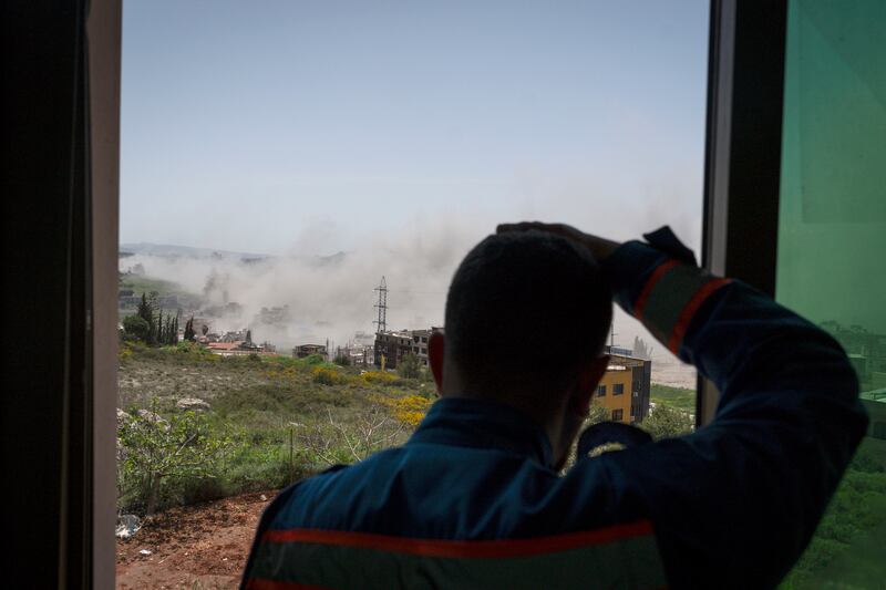A paramedic watches an air strike in Nabatieh, Lebanon. Photograph: Adri Salido/Getty Images