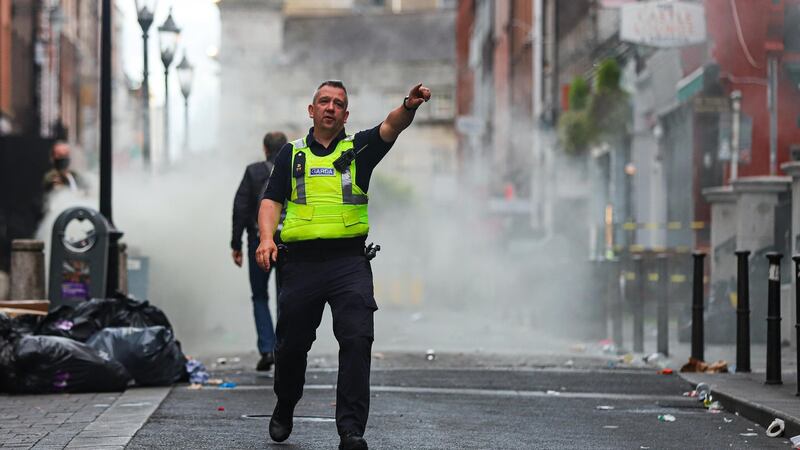 Gardaí clear South William Street on Saturday evening while plumes of smoke come from a rubbish bin in the background. Photograph: Damien Storan