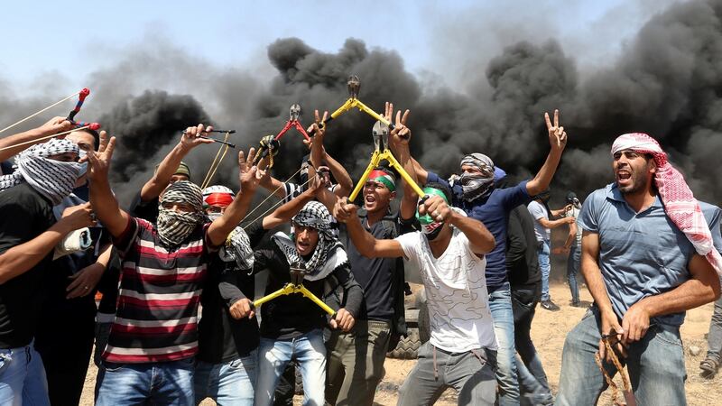 Palestinian demonstrators, some brandishing wire-cutters, gesticulate during a protest demanding the right of return  at the Israel-Gaza border in the southern Gaza Strip, on Friday. Photograph: Ibraheem Abu Mustafa/Reuters