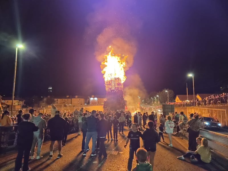 People attend the bonfire in the Bogside in Derry on August 15th.