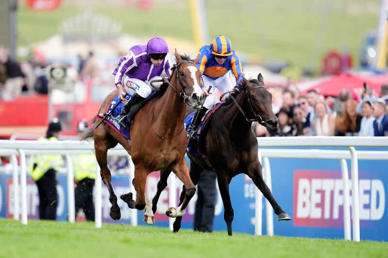 Minnie Hauk ridden by Ryan Moore (left) on their way to winning the Betfred Oaks at Epsom Downs Racecourse. Photograph: Adam Davy/PA Wire
