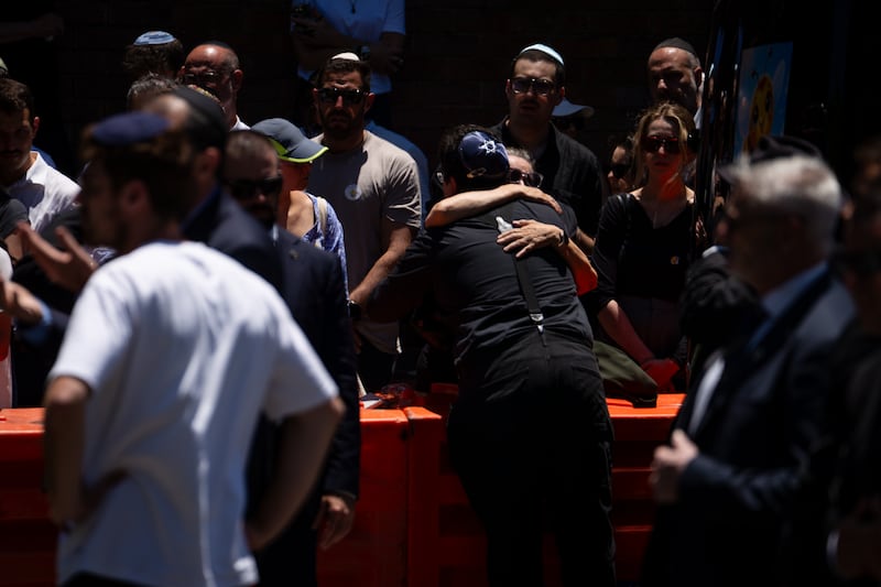 The brother of ten-year-old Matilda, the youngest victim of the Bondi Beach mass shooting, receives a hug during her funeral. Photograph: Audrey Richardson/Getty Images