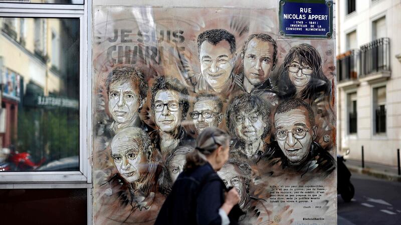 A woman walks past a painting by French street artist and painter Christian Guemy, known as C215, in tribute to staff of the Charlie Hebdo newspaper who were killed in the   January 2015 assault, in Paris on August 31st, 2020. Photograph: Thomas Coex/AFP/Getty