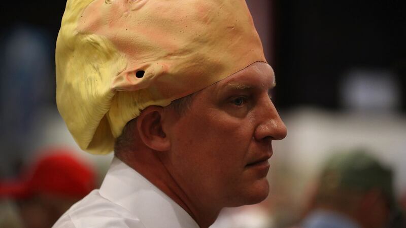 Derek Olsen wears a mask of Republican presidential candidate Donald Trump during his campaign rally  in West Palm Beach, Florida. Photograph:  Joe Raedle/Getty Images