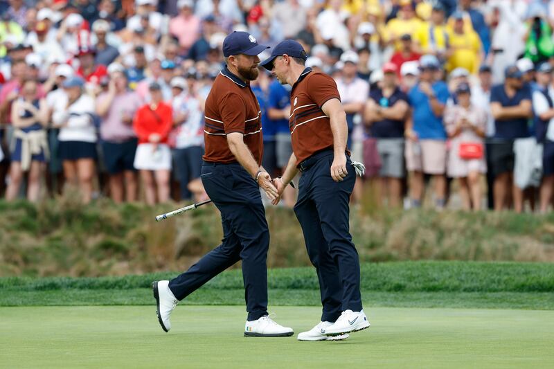 Shane Lowry of Team Europe high-fives teammate Rory McIlroy. Photograph: Harry How/Getty
