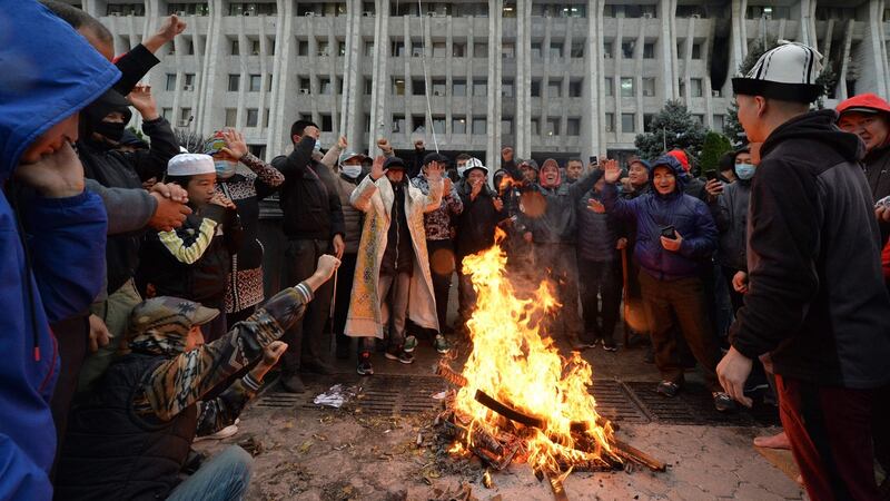 People protesting against the election results outside the government building in Bishkek. Photograph:  Vyacheslav Oseledko/AFP via Getty Images