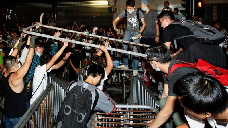 Pro-democracy protesters set up new barricades after riot police retreated from a main road at Mong Kok shopping district in Hong Kong this morning. Photograph: Liau Chung-ren/Reuters