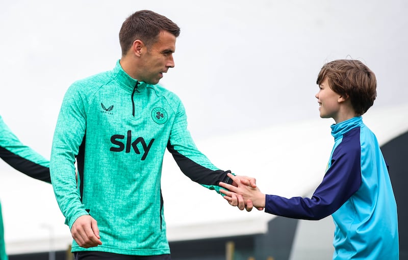 Seamus Coleman greets a young fan. Photograph: Ryan Byrne/Inpho