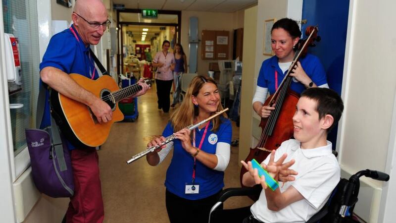 13-year-old Ian Byrne from Bray, Co Wicklow, a patient in Our Lady’sChildrens Hospital, Crumlin, listens to The National Concert Hall Kids’ Classics players Gráinne hope (cello) Julie Maisel (flute) and Liam Merriman (guitar). Photograph: Aidan Crawley