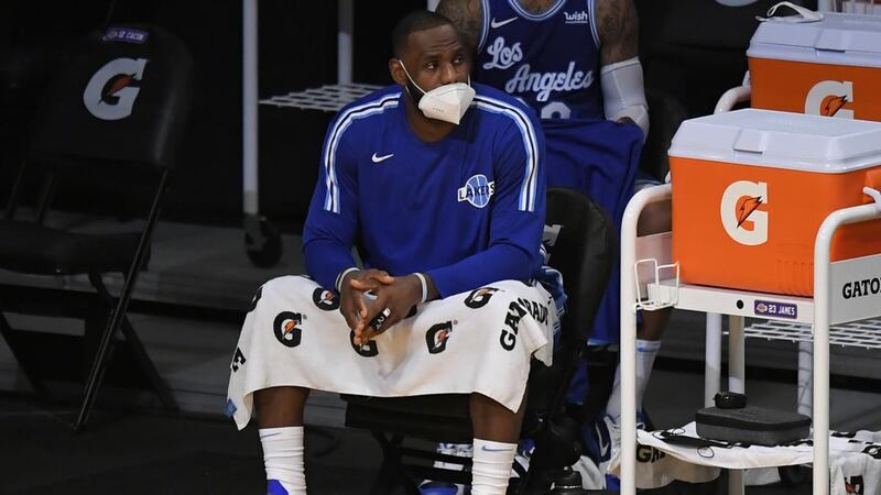 Le Bron James wears a facemask courtside last December. Photograph: John McCoy/Getty
