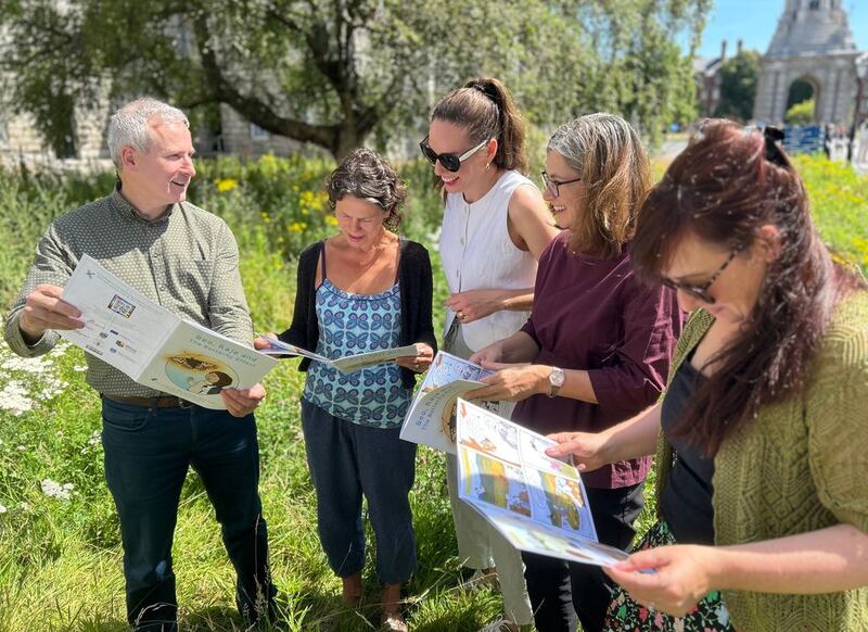 Prof Tom Curran, Prof Catherine Farrell, Dr Máire Nic an Bhaird, Prof Jane Stout and Dr Laoise Ní Chléirigh reading the comic defending insects and highlighting biodiversity in Trinity College's Front Square at the launch Beo, Raja and the Butterfly Effect