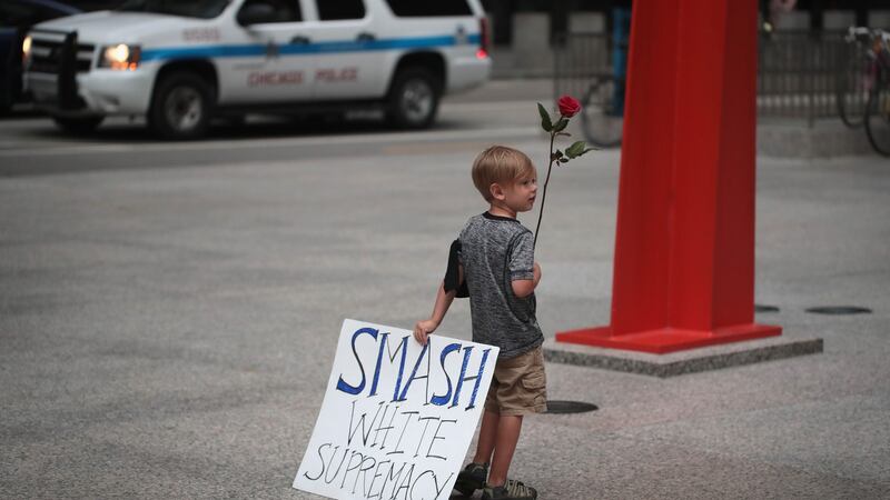 Four-year-old Leo Griffin leaves a protest in Chicago against the alt-right movement held to mourn the victims of thes Charlottesville rally. Photograph:  Scott Olson/Getty Images