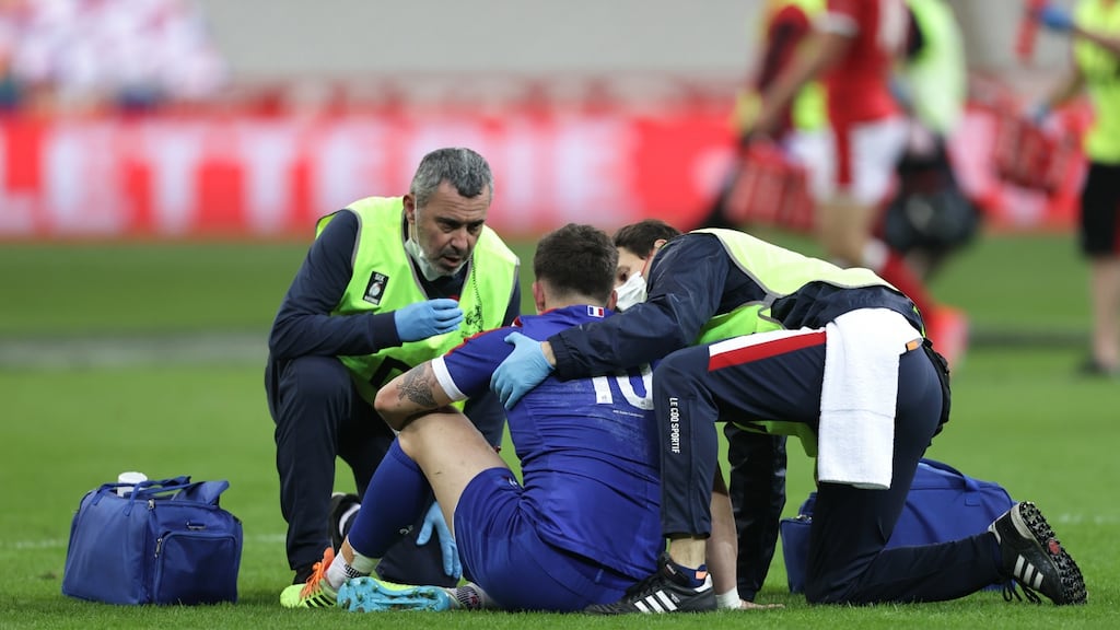France’s Mathieu Jalibert receives attention on the pitch before leaving the field to undergo  a HIA during the Guinness Six Nations match at  Stade de France. Photograph: Laszlo Geczo/Inpho