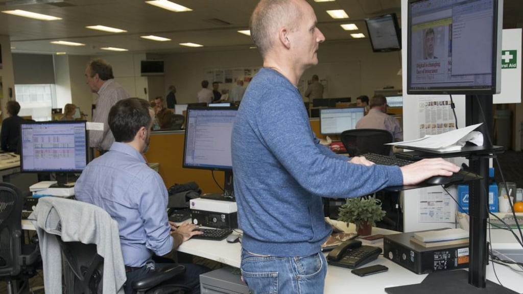 Stand-up guy: Justin Comiskey at his standing desk in the Irish Times newsroom. Photograph: Dave Meehan