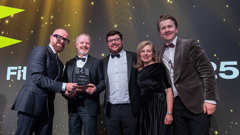 Declan McDonnell, director at MJF Interiors, presents the excellence in design collaboration award to T&I Fitouts and Mola Architecture team