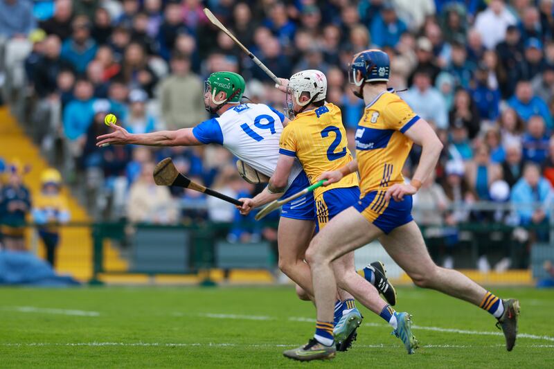 Michael Kiely of Waterford is tackled by Adam Hogan of Clare. Photograph: Natasha Barton/Inpho