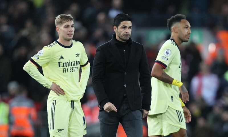 Mikel Arteta and his Arsenal players were dejected after defeat by Liverpool at Anfield in 2021. Photograph: Clive Brunskill/Getty Images