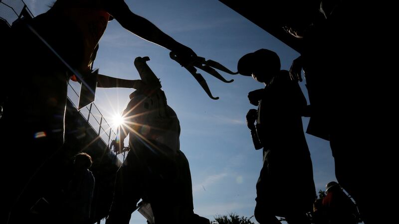 Eclipse glasses are passed around at a  football stadium  at Southern Illinois University in Carbondale, Illinois, US. Photograph: Brian Snyder/Reuters