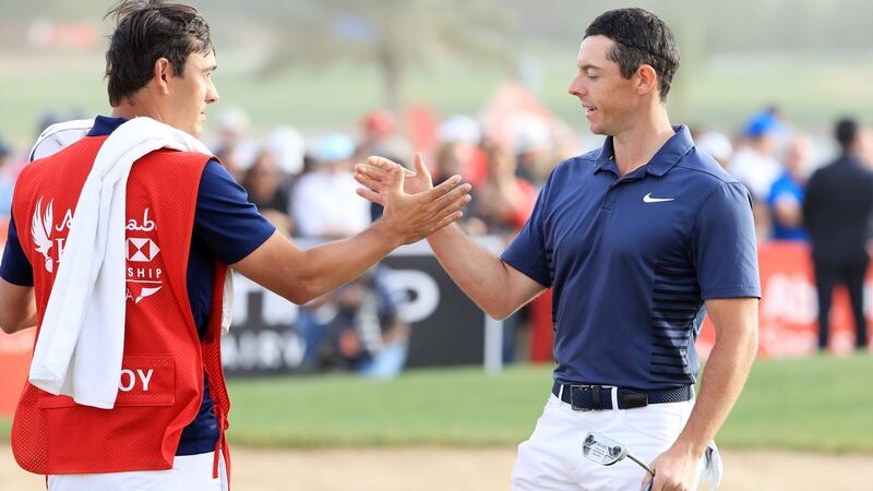 Rory McIlroy shakes hands with caddie Harry Diamond after his final round 70 in Abu Dhabi. Photograph: Andrew Redington/Getty