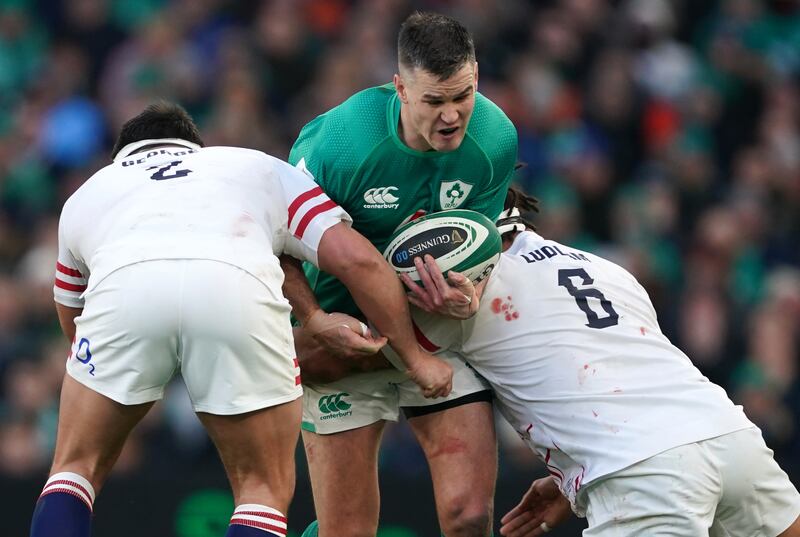 Ireland's Johnny Sexton is tackled by England's Jamie George (left) and Lewis Ludlam during the Guinness Six Nations match at the Aviva Stadium. Photograph: Brian Lawless 