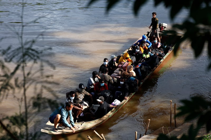 People from various countries cross the Moei river to Thailand in October after the Myanmar military raided one of the country's largest scam centres. Photograph: Sarot Meksophawannakul/Thai News Pix/AFP/Getty