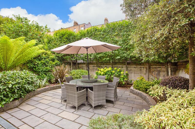 The square back garden is planted for 360-degree privacy 