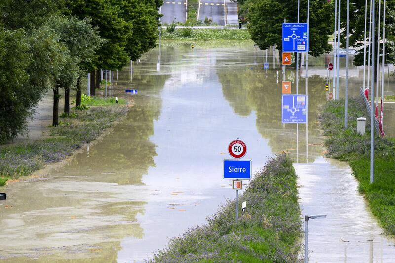 A flooded streeted in Sierre, Switzerland. Photograph: Jean-Christophe Bott/Keystone/AP
