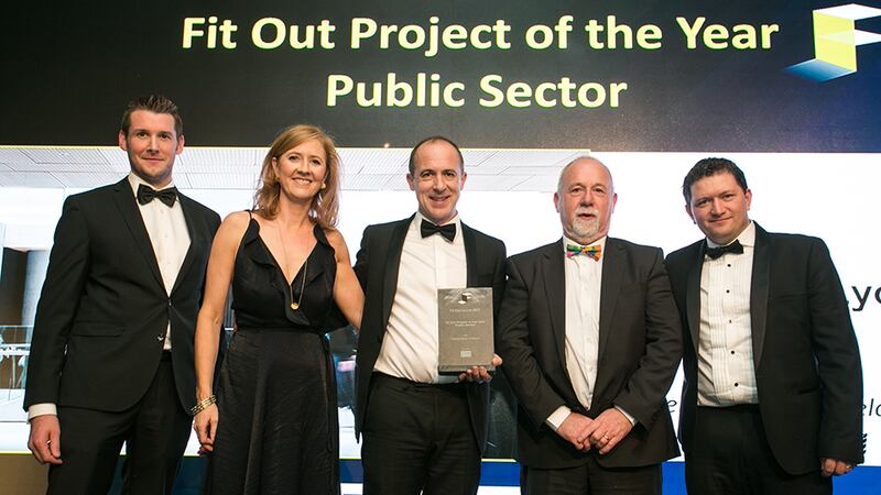 Robbie Hamilton, Managing Director, CRM Interior Fit-Outs presents the Fit Out Project of the Year – 
Public Sector award to the Henry J. Lyons team