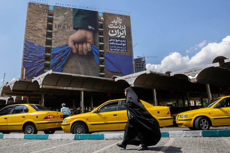 A billboard depicting an arm with an Iranian flag on the sleeve squeezing the Strait of Hormuz in Tehran. Photograph: Arash Khamooshi/The New York Times