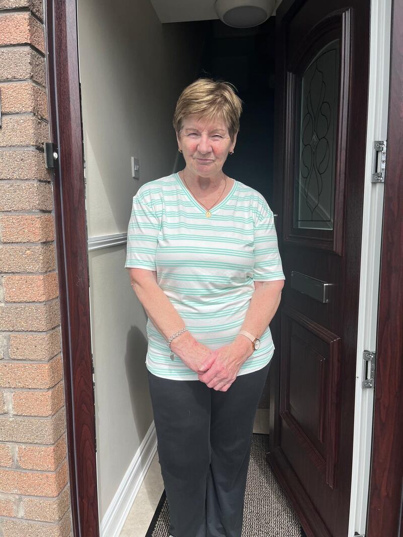 Sheila Melly outside her Dunmurry home, which looks on to the police station.