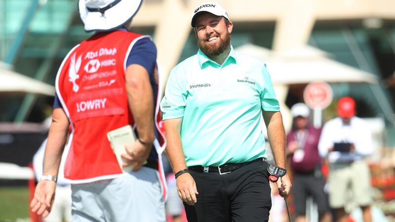 Lowry and caddie Brian “Bo” Martin react on the ninth green after Lowry missed a putt to set a new course record of 61. Photo: Warren Little/Getty Images