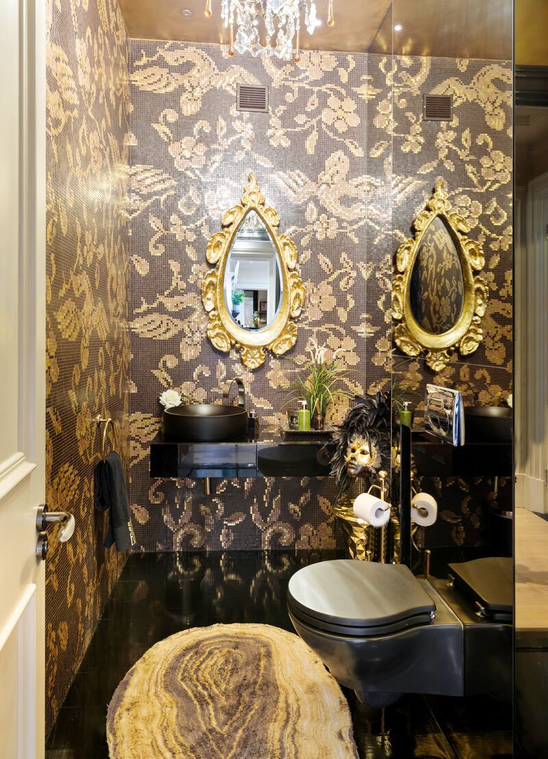 Black-and-gold mosaic-tiled toilet