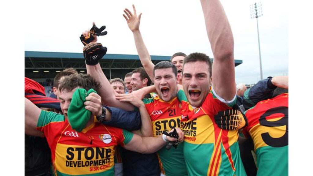 The Carlow team celebrate a famous win over Louth in their Leinster SFC quarter-final in Portlaoise. Photograph: Ryan Byrne/Inpho