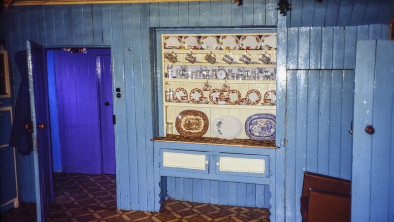Recessed dresser built into a dividing wall of a farmhouse, with palest paintwork for the backing boards and panels. Photograph: Claudia Kinmonth, 1988, Co Cork