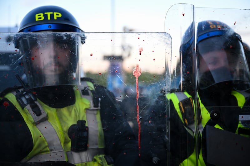 Blood is seen on riot police shields as protesters confront riot police near the location where Henry Nowak died. Photograph: Finnbarr Webster/Getty Images