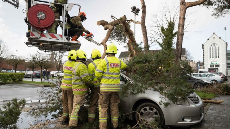 Members of Ennis fire brigade free a car from under a tree felled by Storm Ciara at Friars Walk, Ennis on Sunday morning. Photograpoh by Eamon Ward
