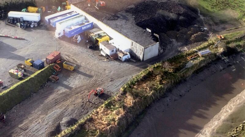 Ferry’s Refuse Collection Limited, near Letterkenny: behind the retaining wall is some of the 14,000 tons of illegally dumped waste which is being covered over by a soil-spreading digger