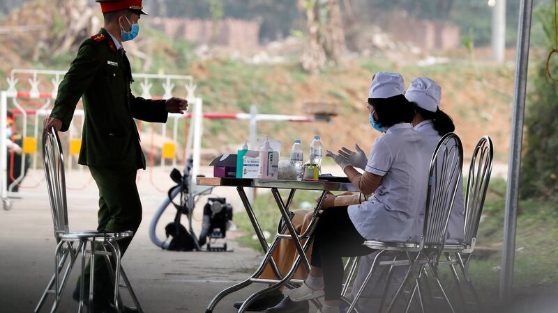 A Vietnamese policeman and two nurses  at a checkpoint at Son Loi commune,  Vinh Phuc province, Vietnam on february 14th. Photograph: Luong Thai Linh/EPA