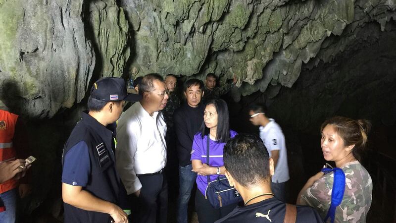 Narongsak Osatanakorn, the governor of Chiang Rai  province, talks to his staff on Saturday at the entrance to the cave where a group of boys and their football coach are missing. Photograph: Chiang Rai city public affairs department via AP