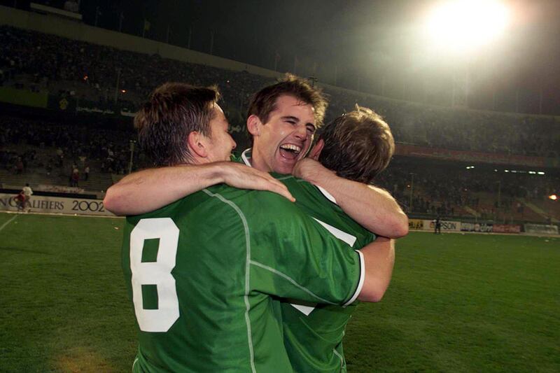 Kevin Kilbane celebrates with Matt Holland and Jason McAteer in Iran after Ireland secure qualification for the 2002 World Cup. Photograph: Andrew Paton/Inpho
