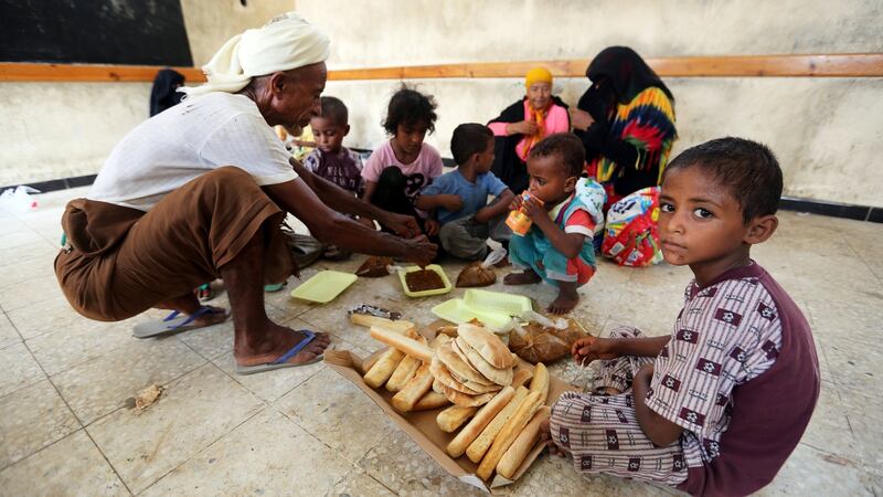 Family members have breakfast at a school to which they have been evacuated from a village near Hodeidah airport amid fighting between government forces and Houthi fighters in Hodeidah, Yemen on Sunday. Photograph: Abduljabbar Zeyad/Reuters