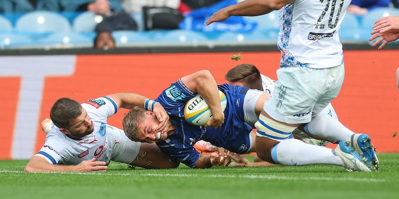 Fintan Gunne scores a try despite the attempt of Willie le Roux to stop him. Photograph: James Crombie/Inpho