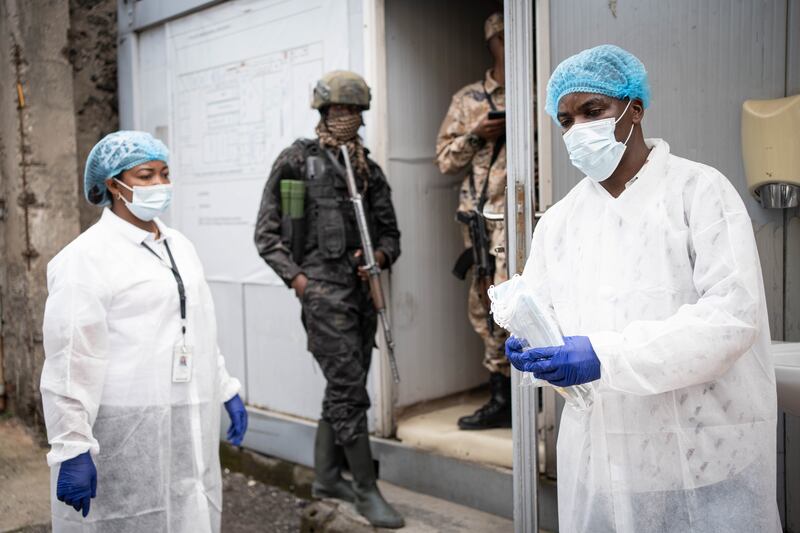 Staff in protective gowns distribute facemaskes in Goma, North Kivu, Democratic Republic of the Congo. Photograph: EPA