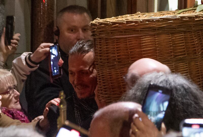 Johnny Depp helps to carry Shane MacGowan's coffin out of church. Photograph: Colin Keegan/Collins