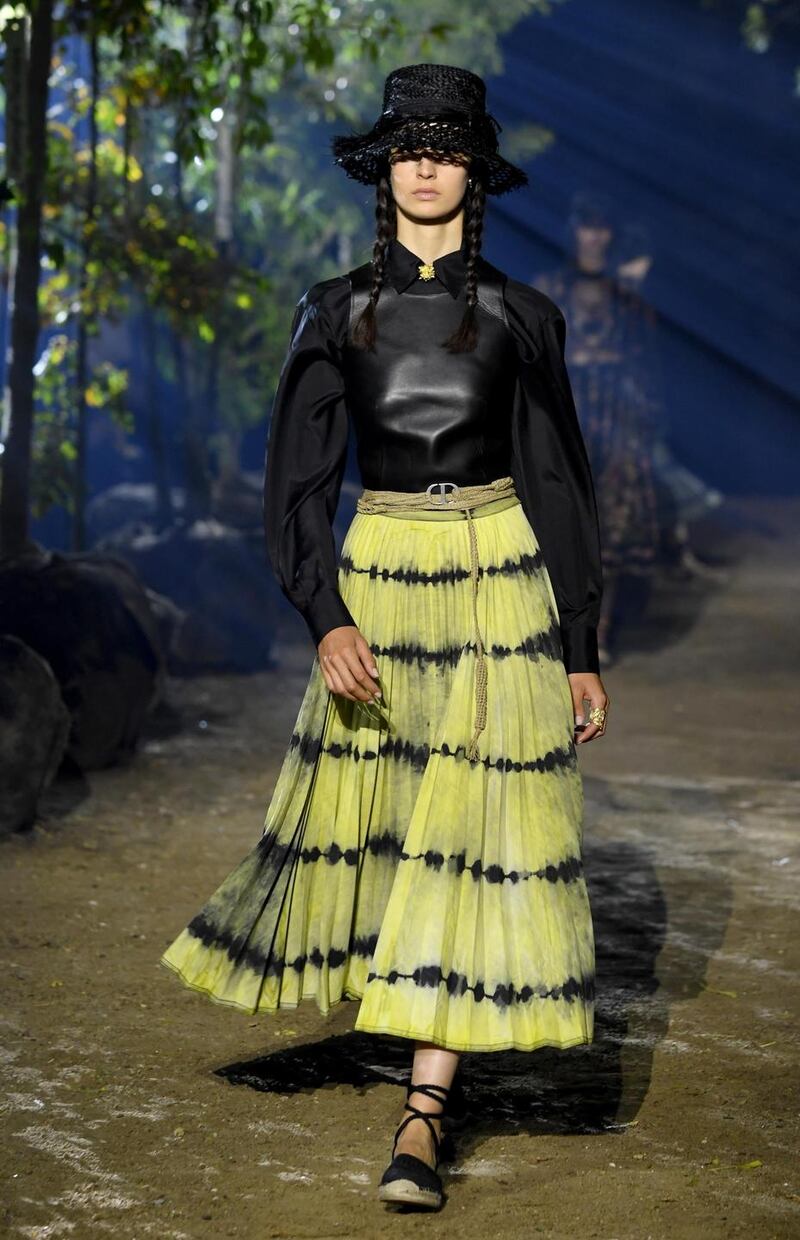 Straw was used in lavishly embroidered raffia skirts, earthy strapless, fringed dresses and basket hats (by Stephen Jones). Photograph:  Pascal Le Segretain/Getty Images