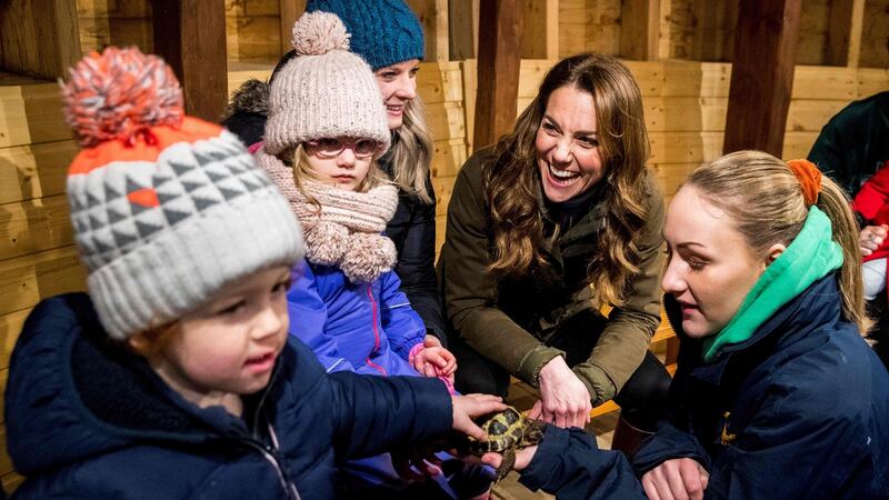 Duchess of Cambridge Kate Middleton reacts as she helps children bottle-feed a lamb during her visit to Ark Open Farm near Belfast on Wednesday. Photograph:  Liam McBurney/ AFP