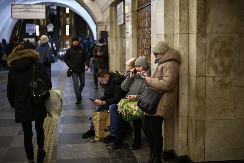 People take shelter during an air raid alert as other commuters pass by at a metro station in Kyiv on Thursday. Photograph: Henry Nicholls/AFP via Getty