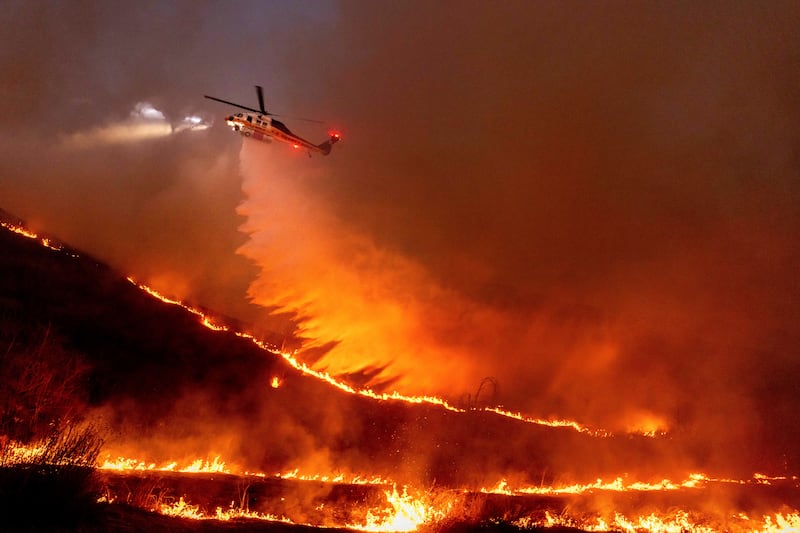 Water is dropped by helicopter on the Kenneth Fire in the West Hills section of Los Angeles, California, in January 2025. Photograph: Ethan Swope/AP